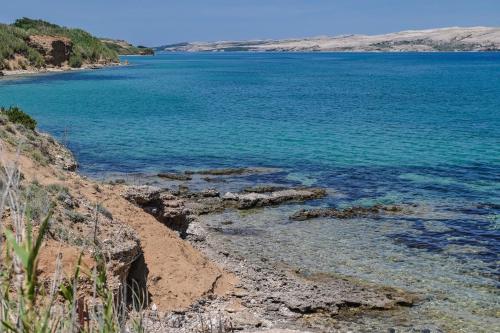 a view of the ocean from a rocky shore at Marianna in Pag - Haus für 5 Personen in Pag