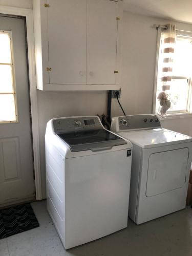 a laundry room with a washer and dryer at Mariners Nest in Saint John