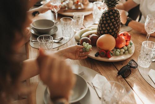 a table with a plate of fruit on it at Villa Maranga in Dombóvár