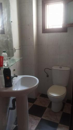 a bathroom with a toilet and a sink at Tetouan city in Tétouan
