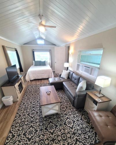 a living room with a couch and a bed at Lazy Oaks Resort Cottages in Leesburg