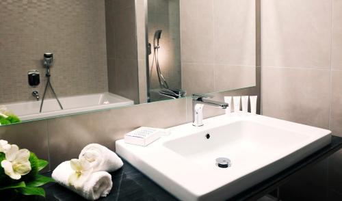 a bathroom with a sink and a bath tub at Hotel Slovenija - Terme & Wellness LifeClass in Portorož