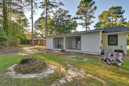a house with two chairs in the yard at Hike and Explore Cheraw Apt 7 Mi to Lake Juniper! in Cheraw