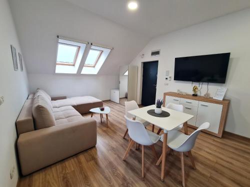 a living room with a couch and a table at Esther Line Apartments - self check-in, free private parking in Timişoara