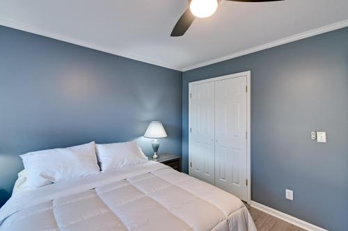 a blue bedroom with a bed and a ceiling fan at Private Patio Apt 6 Mi to Cheraw State Park! in Cheraw