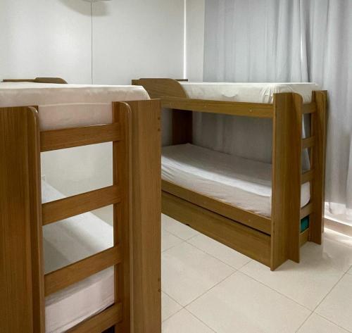 a couple of bunk beds in a room at Casa aconchego in Alcobaça