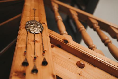 a close up of a wooden railing with a metal object at Villa Maranga in Dombóvár
