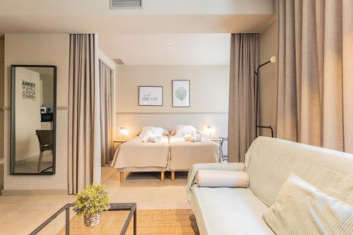 a hotel room with a bed and a couch at Apartamentos 87 Llaves in Valencia