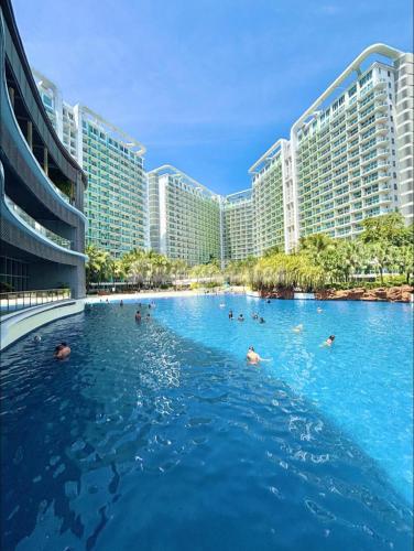 a swimming pool in front of a large building at Azure Staycation by KT in Manila