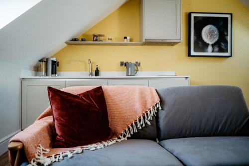 a couch with a blanket on it in a kitchen at The Devonport in Darlington