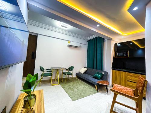 a living room with a couch and a table at Teak Gardens D4 - East Legon in Accra