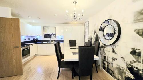 a kitchen with a table and chairs and a dining room at The ascension 'Ascalon ' in London