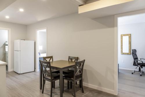 a dining room with a table and chairs and a refrigerator at Motel 6 Merritt, BC in Merritt
