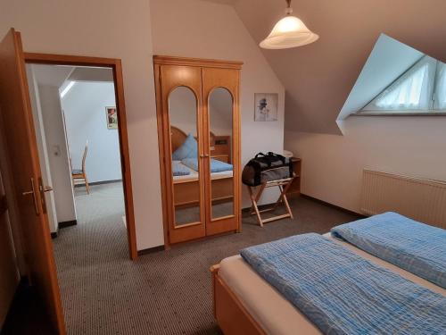 a bedroom with two beds and a dresser and a mirror at Ferienwohnung Woidtraum in Hohenwarth