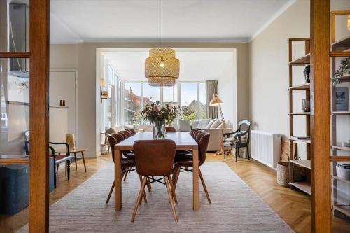 a dining room and living room with a table and chairs at FY399-Bogense-Ostergade-5-a in Bogense