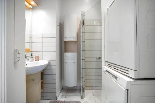 a white kitchen with a sink and a refrigerator at FY399-Bogense-Ostergade-5-a in Bogense