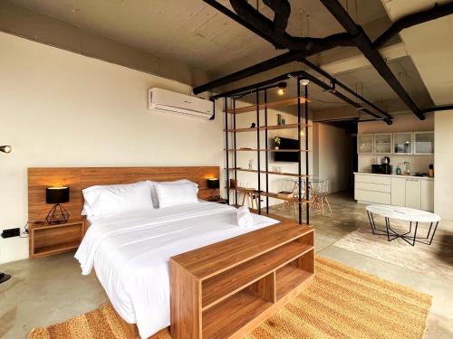 a bedroom with a large bed with a wooden headboard at Enchanted Elegance in Laureles in Medellín