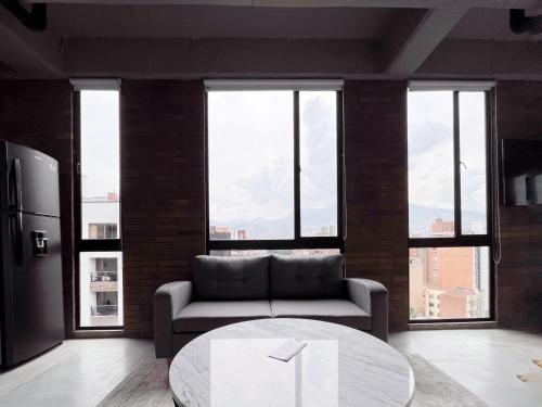 a living room with a couch and a table at Enchanted Elegance in Laureles in Medellín