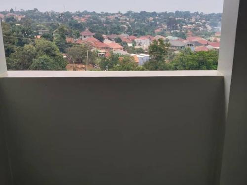 a view of a city from a window in a building at Dopa comfort homes in Entebbe