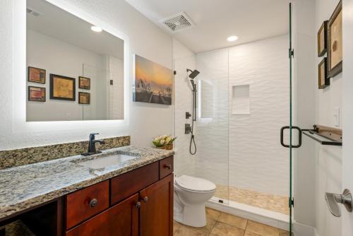 a bathroom with a shower and a toilet and a sink at SC304 - Top of the Banx in Kill Devil Hills