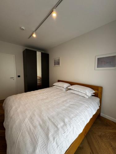 a bedroom with a large white bed with two pillows at RomAir Residences in Cluj-Napoca