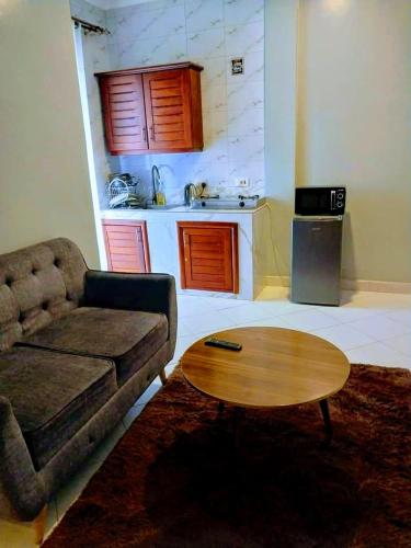 a living room with a couch and a coffee table at Dopa comfort homes in Entebbe