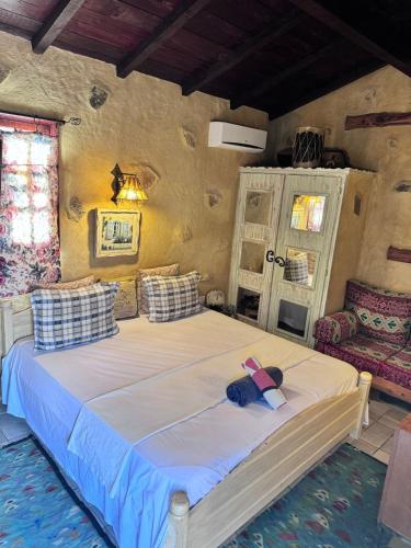 a bedroom with a bed with a pink ribbon on it at Le petit Olivier 