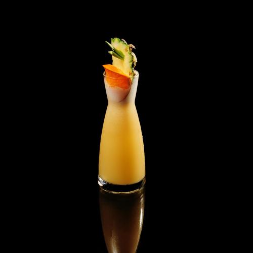 a glass bottle filled with a drink with fruit in it at TRIMULIA Hotel in Sihanoukville