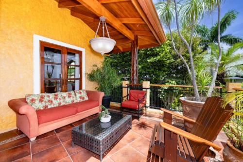 a patio with a couch and a table at Casa Amarilla in Playa Hermosa