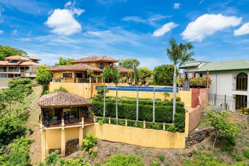 an aerial view of a house with a fence at Casa Amarilla in Playa Hermosa