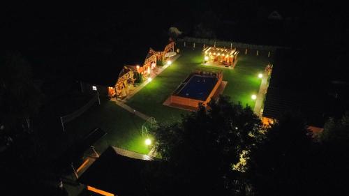 an aerial view of a house with a swimming pool at night at Chatki U Hanusi in Czchów