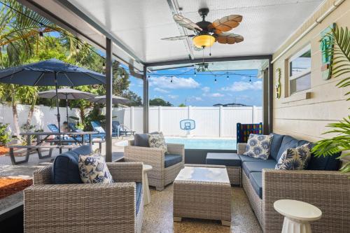 a patio with chairs and tables and a pool at Seminole Shores Private Pool Outdoor Games Wifi in Redington Shores