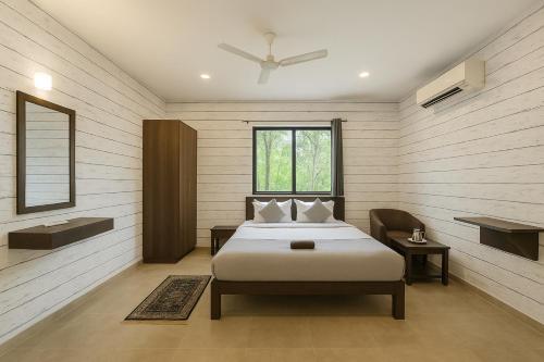 a bedroom with a bed and a window at LUXY Service Apartment at North GOA in Calangute