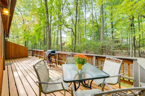 a patio with a table and chairs on a deck at Near Skiing and Lakes Contemporary Poconos Townhome in Lake Harmony
