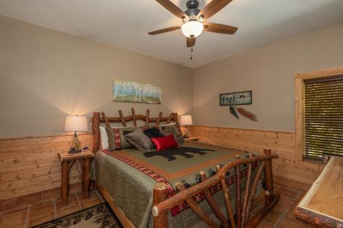 a bedroom with a bed and a ceiling fan at Hawks Heart Lodge by American Patriot Getaways in Shady Grove