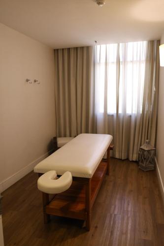 a hospital room with a bed and a window at BOOK A FLAT Alameda Lorena Jardins in Sao Paulo