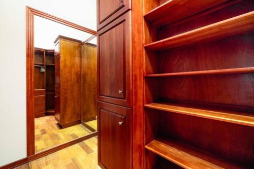 a closet with wooden shelves and a mirror at Casa Texvol in Playa Hermosa