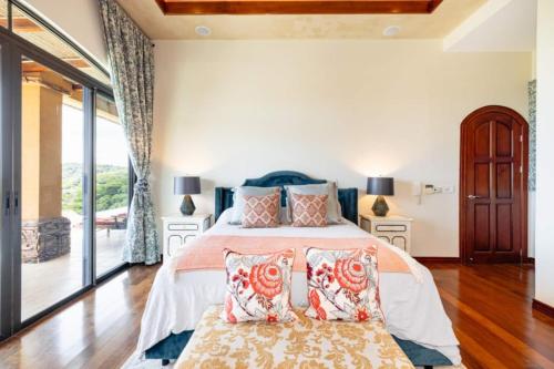 a bedroom with a bed with pillows on it at Casa Texvol in Playa Hermosa