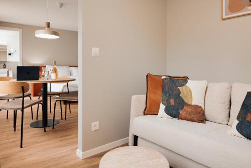 a living room with a couch and a table at Stay Sunday in Zürich