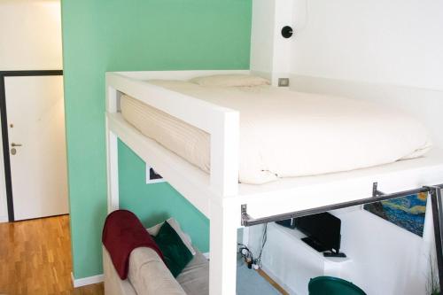two images of a bunk bed in a room at Tajani Room in Milan