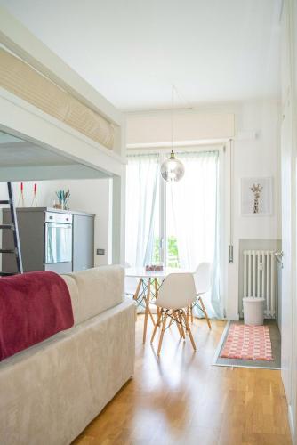 a living room with a couch and a table at Tajani Room in Milan