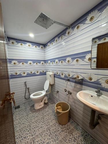 a bathroom with a toilet and a sink at Heres Haut Residency in Ernakulam