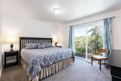 a bedroom with a bed and a large window at Dimple Dell Whole Mountain Setting, Near Trails! in Sandy