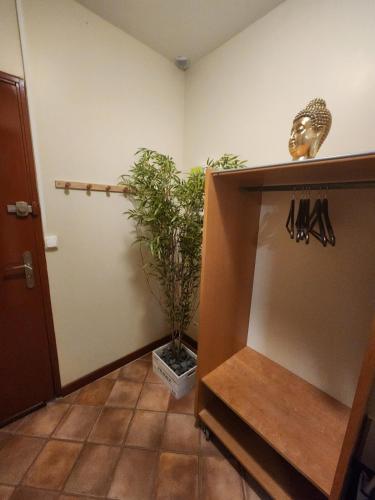 a room with a plant on a shelf next to a door at Le Clos Mauron Numéro 13 in Gray-la-Ville