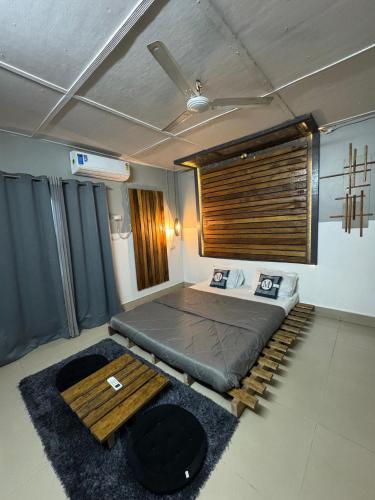 a bedroom with a bed and a ceiling fan at Jajabori homestay in Dibrugarh