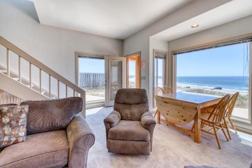 a living room with a couch and a table and chairs at Beach Loop Condo #1 - North Unit in Bandon