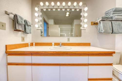 a bathroom with a sink and a mirror at Beach Loop Condo #1 - North Unit in Bandon