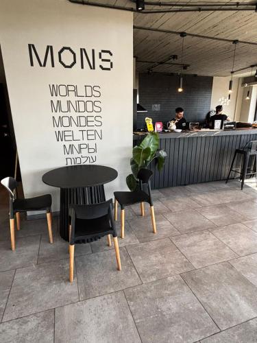 a cafe with a table and chairs and a counter at MONS hostel in Buenos Aires