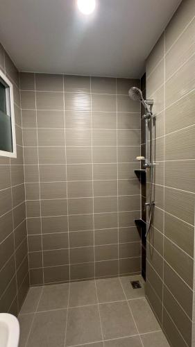 a bathroom with a shower and a toilet at Vela Nakhon Si Thammarat in Nakhon Si Thammarat