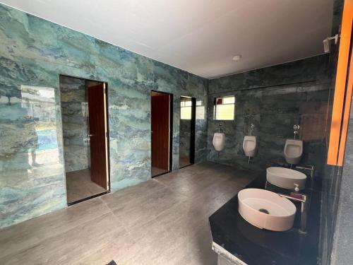 a bathroom with two urinals and a toilet in it at Viroha, Dahanu - Luxury 3BHK Farm Arvind Villa - 121 